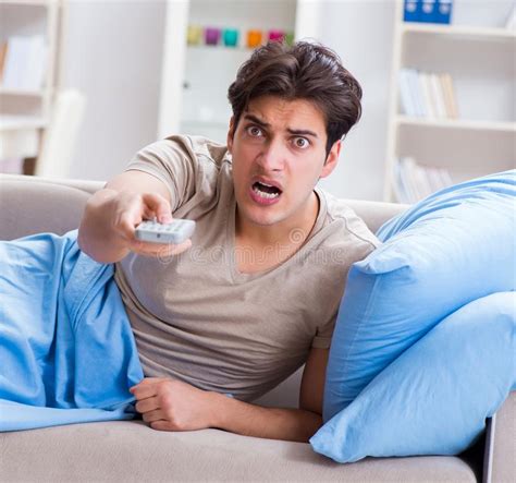 Man Watching Tv From Bed Holding Remote Control Unit Stock Photo
