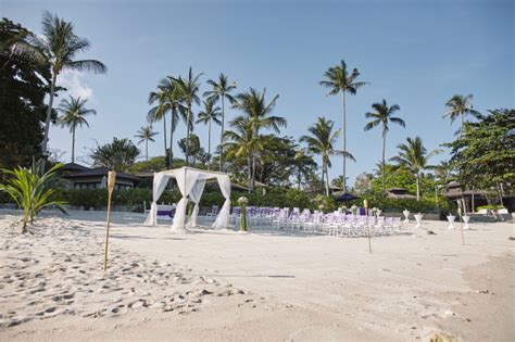 Wedding altar on sandy beach on bali island, indonesia. Beach wedding venue seaside setup, arch, altar, aisle with ...