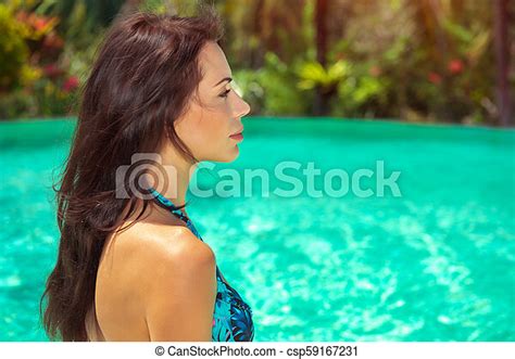Beautiful Woman On The Beach Beautiful Woman Looking On The Turquoise Water In The Pool