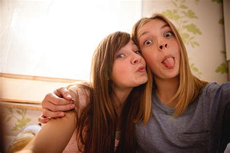 Selfie Portrait Of Girls Sticking Their Tongues Out Stock