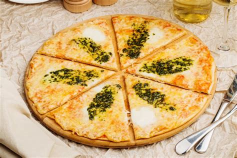 Photo Of Crunchy Pizza On Wooden Plate With Bottle Of Olive Oil Stock