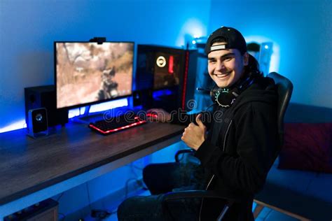 Gamer Smiling After Winning A Match On A Videogame Stock Photo Image