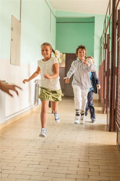 Kids Running Down The School Hallway By Stocksy Contributor Mosuno