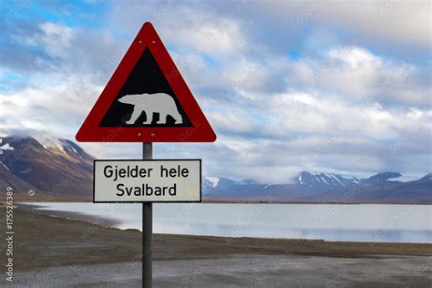 Polar Bear Warning Sign In Svalbard Arctic Landscape With Mountains