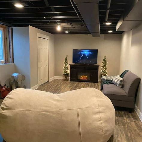 A Living Room Filled With Furniture And A Flat Screen Tv On Top Of A Wall