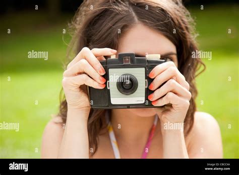 Woman Taking Pictures In Park Stock Photo Alamy