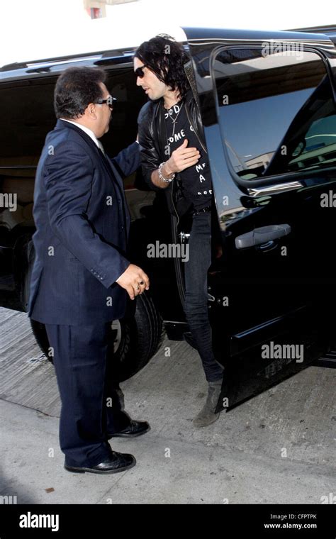 russell brand arriving with his fiancee at lax airport to catch a flight before being arrested