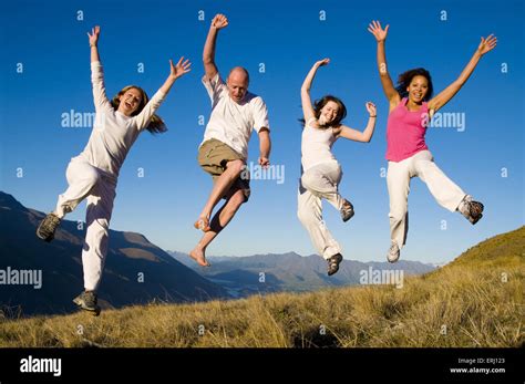 Group Of Young People Jumping In The Field Stock Photo Alamy