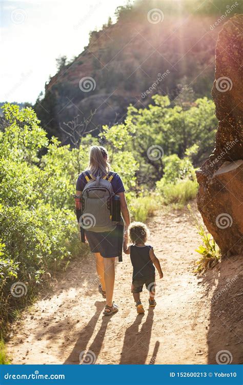 Mother And Child Hiking On A Scenic Mountain Trail Stock Image Image
