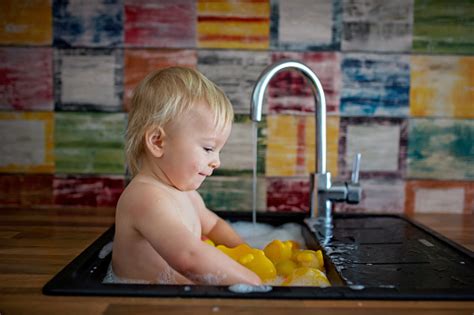 Try our dedicated shopping experience. Cute Smiling Baby Taking Bath In Kitchen Sink Child ...
