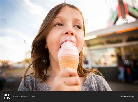 Girl Eating An Ice Cream Cone Stock Photo Offset
