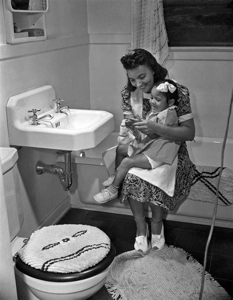 A Mother And Her Daughter Sit On Their Bathtub 1942 Vintage 1940s