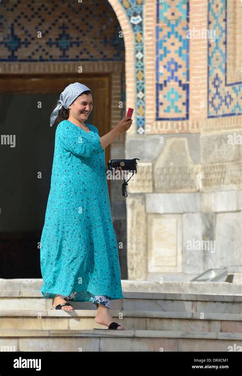 Woman In Traditional Dress Taking Photos With Her Mobile Phone Registan Square Samarkand