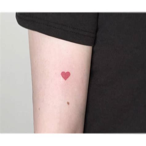 Minimalistic Red Heart Tattoo Located On The Tricep