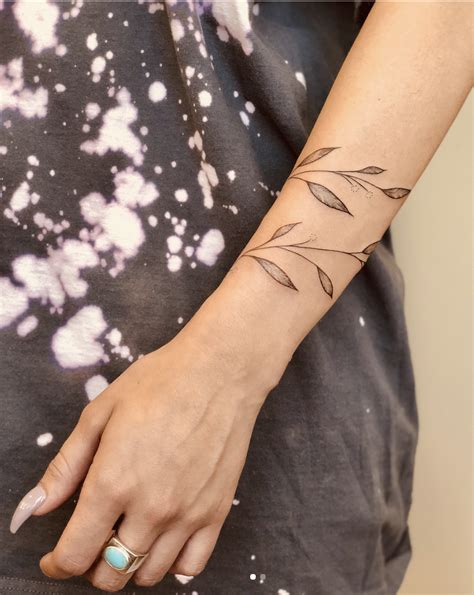 This symbol for maternity tattoo. leaves/branch tattoo | Wrap around tattoo, Wrap around ...