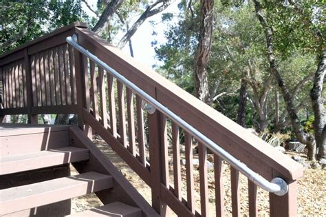 A wooden stair railing is an important safety addition to the porch steps. Handrail for Outdoor Stairs