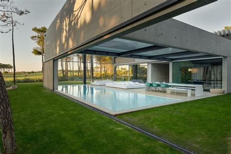 Modern Concrete House With Spiral Staircase And Two Outdoor Pools