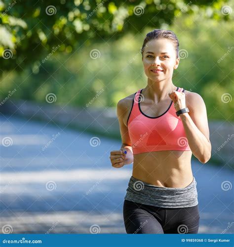 Beautiful Young Woman In Pink Top Jogging In Park Stock Photo Image