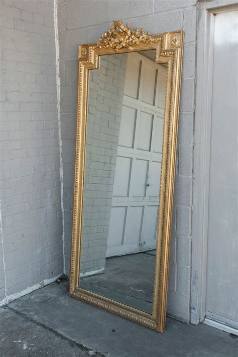 You can also score it with a black, silver, rose gold, or solid wood frame, too. Tall Gold Louis XVI Giltwood Full-Length Mirror with Crown of Ribbons at 1stdibs