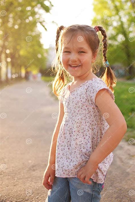 Little Smiling Girl With Pigtails In The Sunlight Stock Photo Image