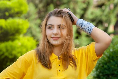 Beautiful Teenage Girl In Yellow Shirt In Old City Park Stock Image