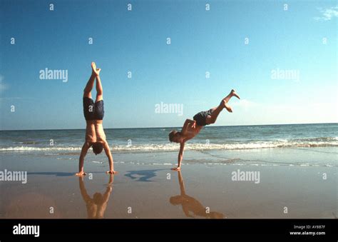 Two Boys Doing Handstands On The Beach Camber Sands East Sussex Uk Site