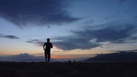 The first three stanzas of the poem speak the gradual onset of night elevates the calm mood of the poem. Man Walking On The Beach At Night Stock Footage Video ...