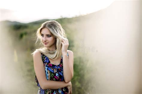 Beautiful Dreamy Blonde Girl With Blue Eyes In A Light Turquoise Dress