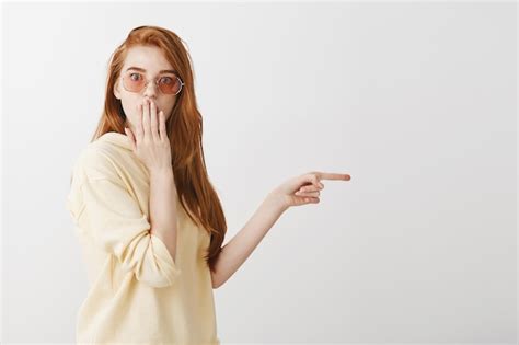 Free Photo Shocked And Astounded Redhead Girl Pointing Finger Right