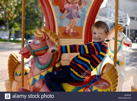 Little Boy 6 7 Riding Carousel Horse Stock Photo Alamy