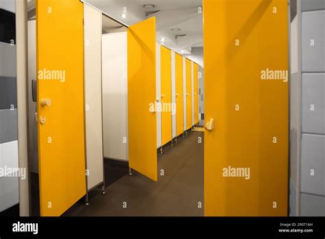 Public Toilet Interior With Bright Yellow Stalls Stock Photo Alamy