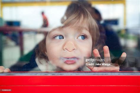 Boy Looking Out Window High Res Stock Photo Getty Images
