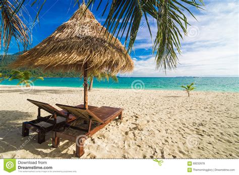 Vacation Time Background Of Two Beach Lounge Chairs Under Grass Stock