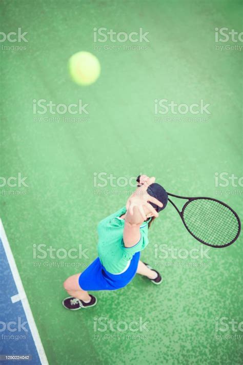 Athletic Female Serving Tennis Ball Stock Photo Download Image Now