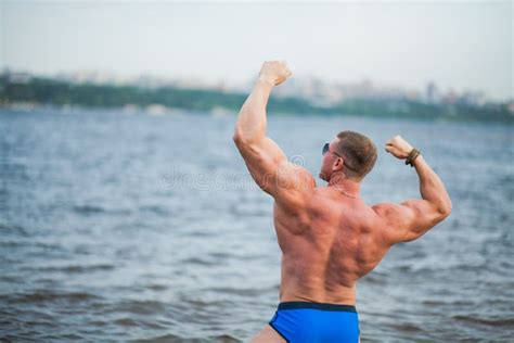 Fit Muscular Athletic Man Posing With Hands Up In River Water Stock
