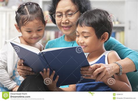 Grandma And Grandchildren Reading Book Together Stock