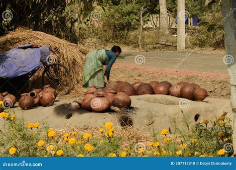 Village Woman Arranging Earthen Pot For Jaggery Making At Henry Island