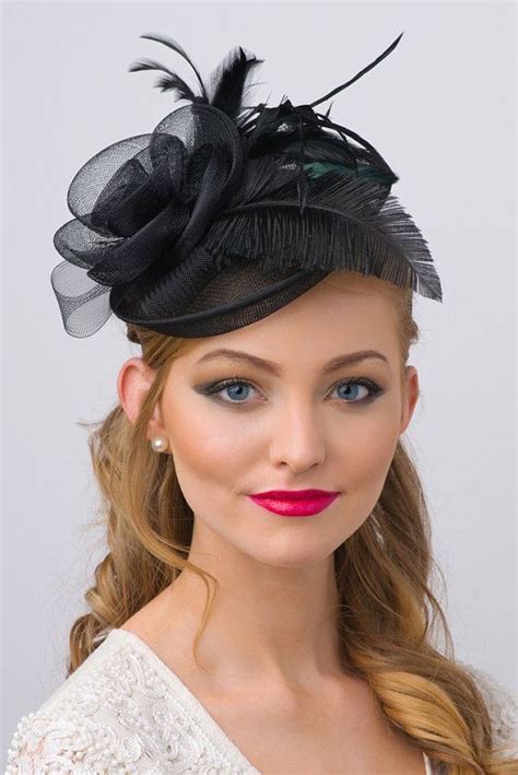 A Woman Wearing A Black Hat With Feathers On It S Head And Red Lipstick
