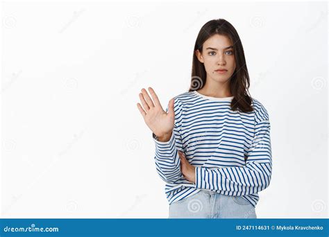 Image Of Serious Reluctant Girl Rejecting Waving Hand To Give Negative