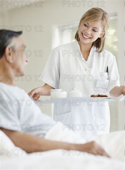 Nurse Giving Tray Of Food To Patient Photo Momentimages Photo12