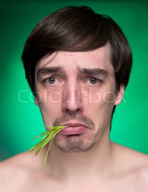 Young Man Eating A Bunch Of Fresh Green Grass Stock Image Colourbox