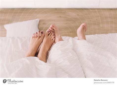 Two Pairs Of Feet Appear Below The Sheet A Royalty Free Stock Photo From Photocase