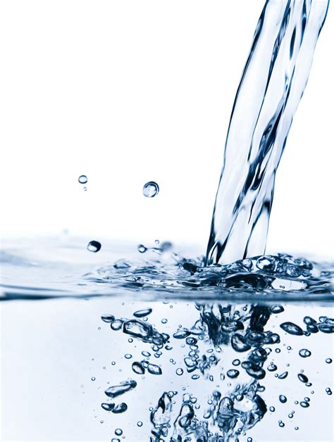 Water Pouring From A Faucet Into A Body Of Water With Bubbles On It