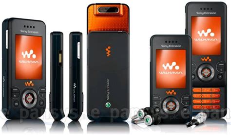 An Orange And Black Cell Phone Is Next To Other Electronic Devices With