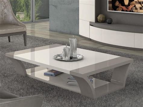 A coffee table is a low table designed to be placed in a sitting area for convenient support of beverages, remote controls, magazines, books (especially large, illustrated coffee table books), decorative objects, and other small items. Carlotta modern coffee table in ivory and beige grey high ...