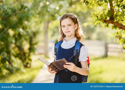 Ten Year Old Schoolgirl With A Book In The Outdoors Stock Photo Image