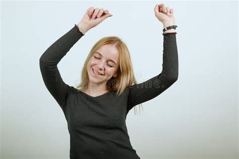 Happy Girl Smiles Holds Hands Above Her Head And Dances The Concept Of Happy Stock Image
