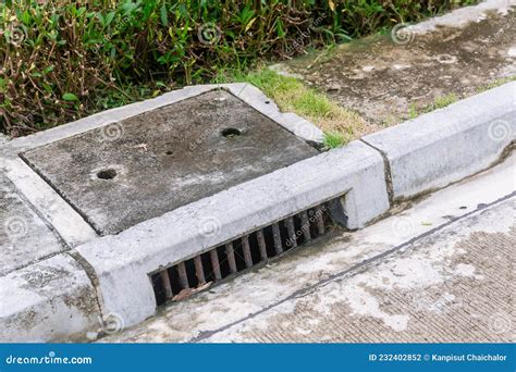 Sewer Drain Along Road A Storm Drain On The Side Of A Road Suburban