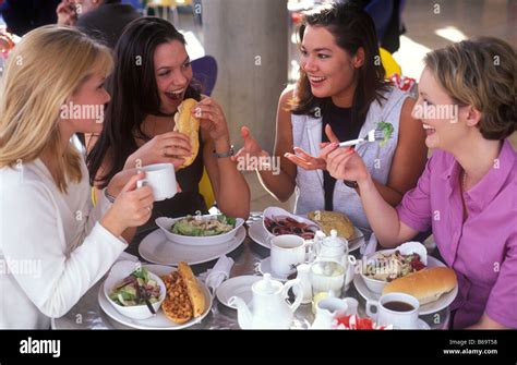 Four Young Women Having Lunch Together In A Cafe Stock Photo 21114836