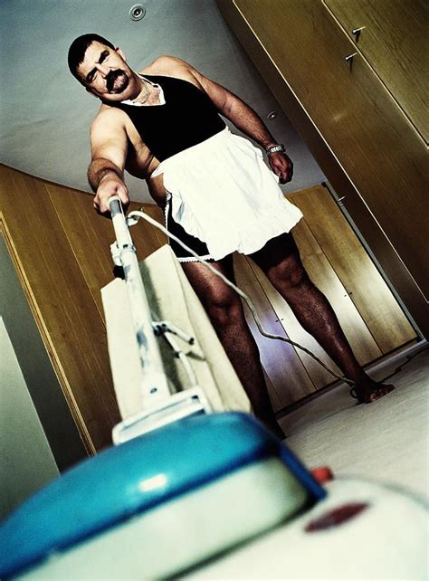 Overweight Man Wearing French Maid Outfit Vacuuming Floor Portrait